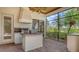 An outdoor kitchen on a screened-in patio with a grill and nice counter space at 6919 Dominion Ln, Lakewood Ranch, FL 34202