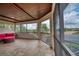 Screened-in outdoor patio with comfortable seating and a wood-paneled ceiling with a view at 6919 Dominion Ln, Lakewood Ranch, FL 34202