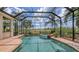Screened in pool with spa, brick trim, and professional landscaping at 6919 Dominion Ln, Lakewood Ranch, FL 34202