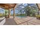 Enclosed pool and spa with a brick pool deck and unobstructed backyard views at 6919 Dominion Ln, Lakewood Ranch, FL 34202