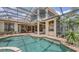 Back exterior of the house showing a large pool and outdoor kitchen area at 6919 Dominion Ln, Lakewood Ranch, FL 34202