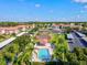 Beautiful aerial view showcasing the community pool, cabana, tennis court, parking, and well-maintained apartment buildings at 7039 Strand Cir # 34-201, Bradenton, FL 34203