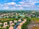 Aerial view showcasing the beautiful neighborhood with winding lakes, lush trees and well-maintained lawns at 7039 Strand Cir # 34-201, Bradenton, FL 34203
