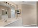 Bathroom featuring a double sink vanity, large mirrors, and neutral color palette at 7039 Strand Cir # 34-201, Bradenton, FL 34203