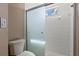 Modern bathroom featuring tiled shower with glass sliding doors and updated fixtures at 7039 Strand Cir # 34-201, Bradenton, FL 34203
