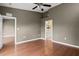 Bright and airy bedroom with hardwood floors, a ceiling fan, and an ensuite bathroom at 7039 Strand Cir # 34-201, Bradenton, FL 34203