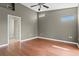 Bright bedroom with wood floors, neutral walls, and transom windows for natural light at 7039 Strand Cir # 34-201, Bradenton, FL 34203