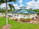 Charming clubhouse with a green roof, solar panels, landscaped gardens, and a welcoming entrance for community gatherings at 7039 Strand Cir # 34-201, Bradenton, FL 34203
