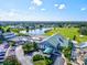 Aerial shot of a clubhouse, lake, tennis courts, pool, golf course and well-manicured lawns in a vibrant community setting at 7039 Strand Cir # 34-201, Bradenton, FL 34203