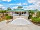 Exterior of the clubhouse with an grand entry staircase and inviting veranda at 7039 Strand Cir # 34-201, Bradenton, FL 34203
