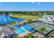 Extensive aerial view of community amenities including pool, lake, golf course, tennis court and clubhouse at 7039 Strand Cir # 34-201, Bradenton, FL 34203