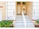 Well-maintained front entrance with concrete steps and white railings that lead to each unit's front door at 7039 Strand Cir # 34-201, Bradenton, FL 34203