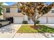 Charming front exterior with driveways, garages, an ornamental tree, and manicured lawn and shrubbery at 7039 Strand Cir # 34-201, Bradenton, FL 34203