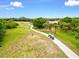 Golf course view, showing a scenic cart path winding through lush green fairways at 7039 Strand Cir # 34-201, Bradenton, FL 34203