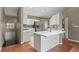 Modern kitchen with white cabinets, a stainless-steel refrigerator, mosaic backsplash, and tiled flooring at 7039 Strand Cir # 34-201, Bradenton, FL 34203