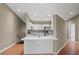 Contemporary kitchen featuring recessed lighting, white cabinets, a stainless-steel refrigerator, and hardwood flooring at 7039 Strand Cir # 34-201, Bradenton, FL 34203