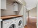 Convenient laundry room features modern LG washer and dryer and built in shelf at 7039 Strand Cir # 34-201, Bradenton, FL 34203