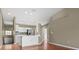 Open living space with wood floors, a kitchen with stainless appliances, and neutral-colored walls at 7039 Strand Cir # 34-201, Bradenton, FL 34203