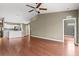 Open living space featuring hardwood floors, neutral wall color, and an adjacent kitchen with stainless steel appliances at 7039 Strand Cir # 34-201, Bradenton, FL 34203