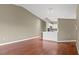 Open living space with wood floors and view into the kitchen at 7039 Strand Cir # 34-201, Bradenton, FL 34203