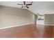 View of a large, open-plan living area featuring hardwood flooring and neutral wall color, adjacent to a kitchen at 7039 Strand Cir # 34-201, Bradenton, FL 34203