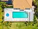 Aerial shot of private pool with ample seating and shade with well manicured plants at 7039 Strand Cir # 34-201, Bradenton, FL 34203