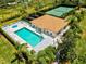 Community pool area featuring a lounge, swimming pool, jacuzzi and lush landscaping at 7039 Strand Cir # 34-201, Bradenton, FL 34203