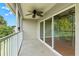 A large, screened-in porch featuring a ceiling fan, and sliding glass doors at 7039 Strand Cir # 34-201, Bradenton, FL 34203