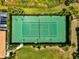 Aerial view of a well-maintained tennis court surrounded by lush landscaping and greenery at 7039 Strand Cir # 34-201, Bradenton, FL 34203