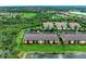 Aerial view of community featuring manicured lawns, tile roofs and a pond at 7315 River Hammock Dr # 101, Bradenton, FL 34212