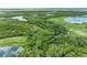 Aerial view of lush, green nature preserve with a golf course, several lakes and waterways at 7315 River Hammock Dr # 101, Bradenton, FL 34212