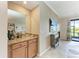 Cozy bar area with a granite countertop, wooden cabinets, and a view of the living area at 7315 River Hammock Dr # 101, Bradenton, FL 34212