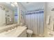 Bathroom features a single sink vanity, decorative mirror, toilet and shower/tub combo at 7315 River Hammock Dr # 101, Bradenton, FL 34212