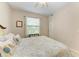 Cozy bedroom features a floral quilt, natural light and a closet at 7315 River Hammock Dr # 101, Bradenton, FL 34212