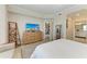 Bedroom featuring light wood floors, a dresser with TV and a comfy chair at 7315 River Hammock Dr # 101, Bradenton, FL 34212