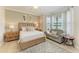Bright bedroom boasts light wood floors, neutral paint, bay window and ceiling fan at 7315 River Hammock Dr # 101, Bradenton, FL 34212