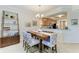 Chic dining area with an elegant chandelier, modern decor, and open access to the kitchen at 7315 River Hammock Dr # 101, Bradenton, FL 34212