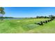 Well-maintained driving range overlooking a lake and green grass, ideal for golfers at 7315 River Hammock Dr # 101, Bradenton, FL 34212