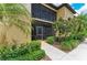 Inviting condo entrance with lush landscaping and covered balcony at 7315 River Hammock Dr # 101, Bradenton, FL 34212