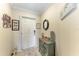 Welcoming entryway featuring a stylish cabinet, decorative mirror, and tasteful wall art at 7315 River Hammock Dr # 101, Bradenton, FL 34212