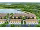 Beautiful condo building exterior featuring tropical landscaping and tile roofs at 7315 River Hammock Dr # 101, Bradenton, FL 34212