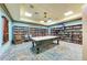 Inviting game room featuring a pool table, a large bookshelf, and a relaxing atmosphere for leisure and entertainment at 7315 River Hammock Dr # 101, Bradenton, FL 34212