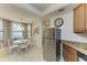 Eat-in kitchen features stainless steel refrigerator, round table and modern decor at 7315 River Hammock Dr # 101, Bradenton, FL 34212
