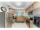 Well-equipped kitchen with stainless steel appliances, breakfast bar, and granite countertops at 7315 River Hammock Dr # 101, Bradenton, FL 34212