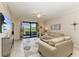 Comfortable living room with neutral tones, access to the lanai, and views of the landscaped surroundings at 7315 River Hammock Dr # 101, Bradenton, FL 34212