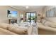 Inviting living room with plush seating, a large TV, and a serene view of the outdoor area at 7315 River Hammock Dr # 101, Bradenton, FL 34212