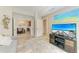 Open-concept living area featuring a plush gray sofa, media center, and access to dining and kitchen at 7315 River Hammock Dr # 101, Bradenton, FL 34212