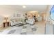 Spacious living room with tile flooring, comfortable sofas, and an open view to the dining area at 7315 River Hammock Dr # 101, Bradenton, FL 34212
