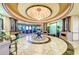 Opulent lobby with high ceilings, marble floors, elegant decor, seating, and a grand chandelier at 7315 River Hammock Dr # 101, Bradenton, FL 34212