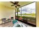 Screened in patio features a scenic view of the water and seating area at 7315 River Hammock Dr # 101, Bradenton, FL 34212